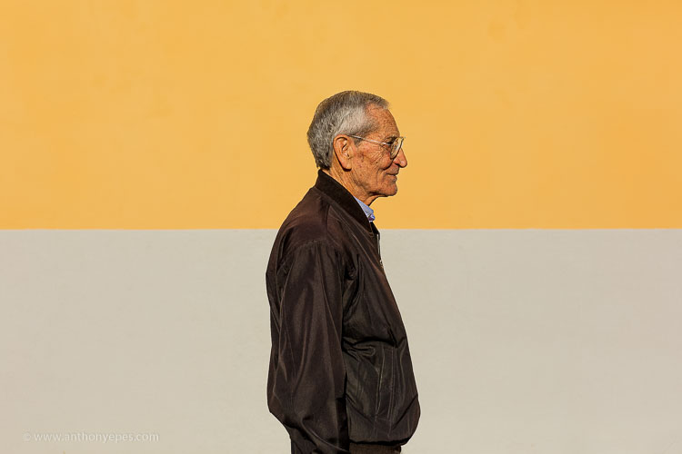 man walking in front of colorful background