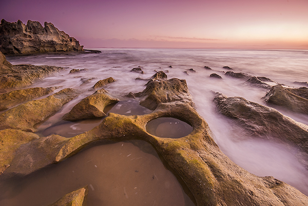 rocky shoreline at sunset