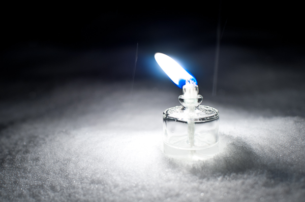 blue flame in a bottle on snow