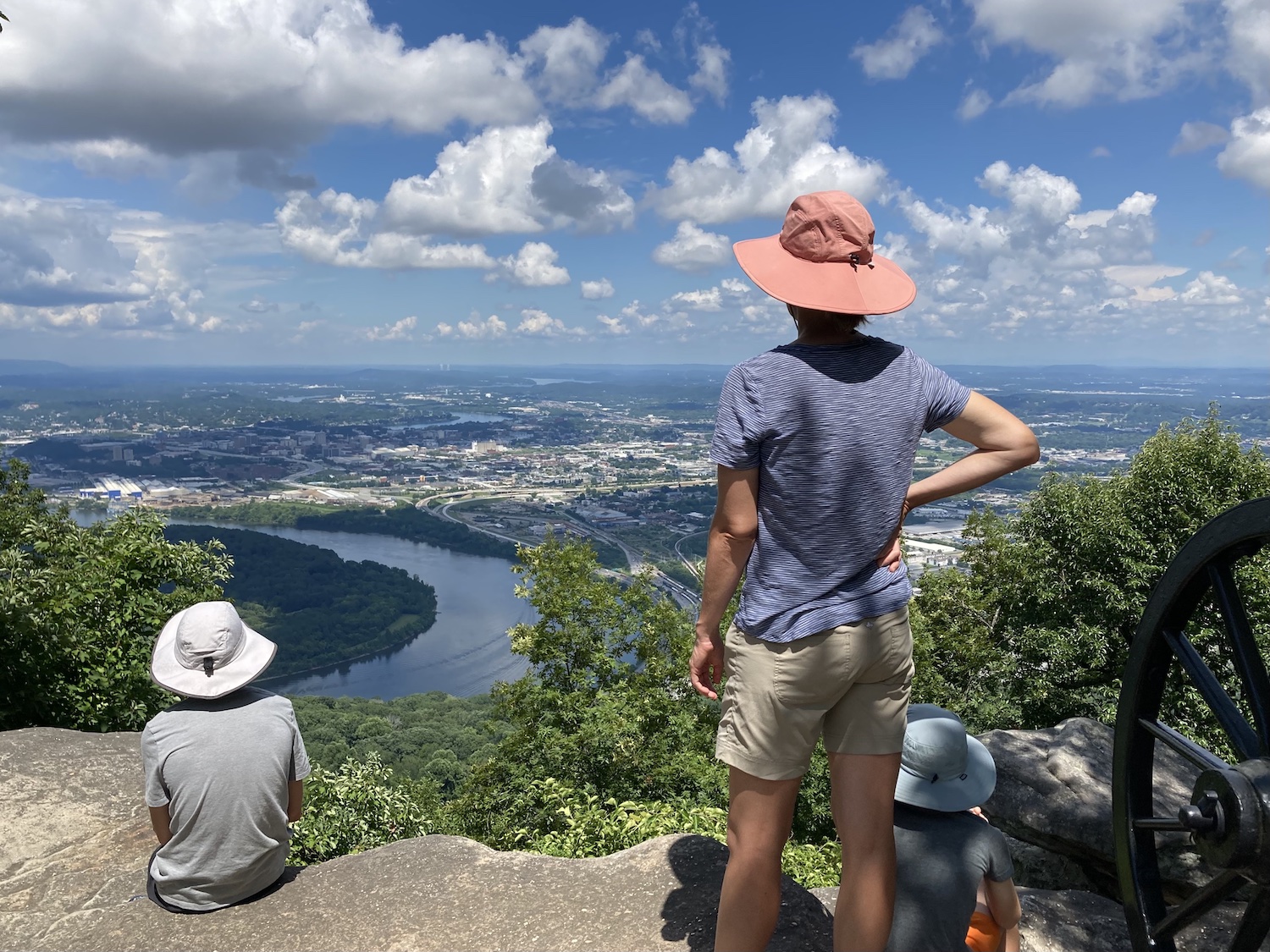 JPEG vs HEIC: Tourists looking out over a city and a river from on top of a mountain.