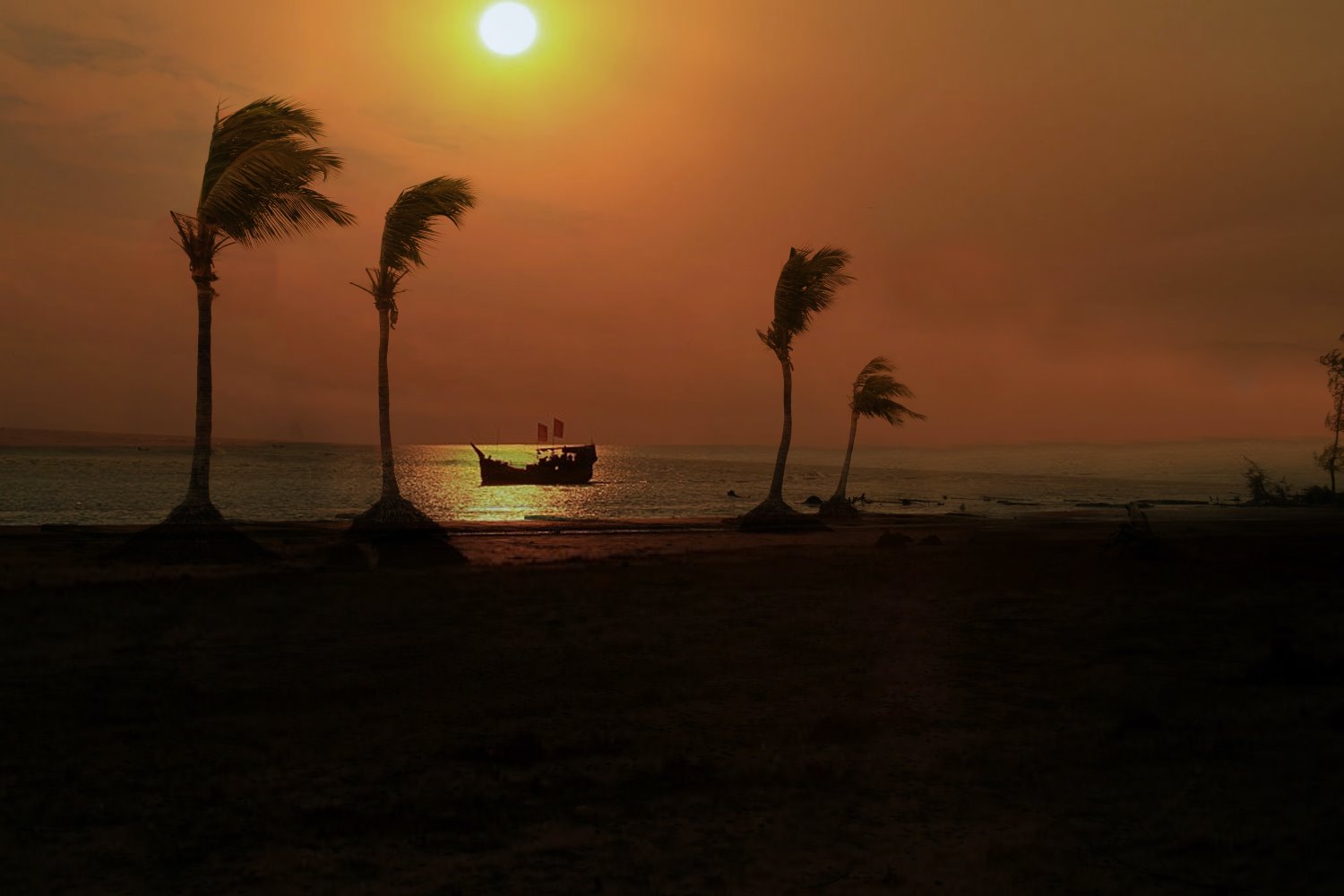 silhouetted boat off a beach